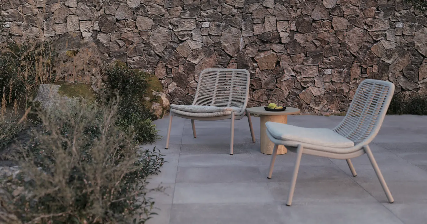 Philia rope lounge chairs on a stone terrace, rendered by the factory