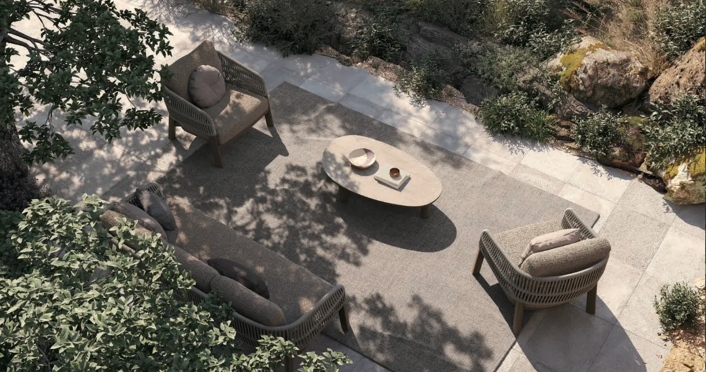 Factory rendering: Overhead view of a Roro lounge set with a sofa, two lounge chairs and an oval coffee table in dappled shade